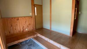 an empty room with a wooden floor and a door at 民泊浜田 蛍の里 in Hamada +18 photos