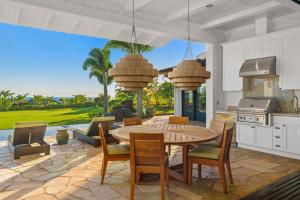 a kitchen and dining room with a table and chairs at Luxury 6BR Ocean View Estate Home in Kukuiula in Kukuiula