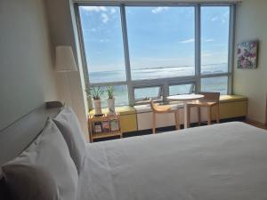 a bedroom with a bed and a table and chairs at Cozy - Sunny Studio in Incheon +1 photo