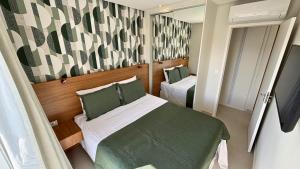 Postel nebo postele na pokoji v ubytování Book Santos Unlimited 1809 - Vista Mar & Piscina