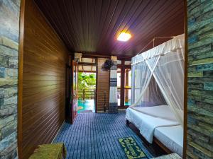 a bedroom with a bed with a mosquito net at Ella Happy View Homestay in Ella