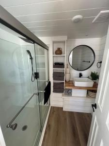a bathroom with a shower and a mirror at Tiny Home Lodge Near Zion National Park Breathtaking Views in Apple Valley +12 photos