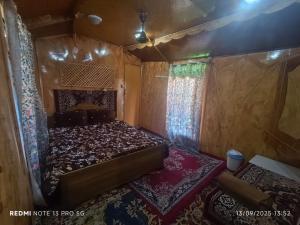a small room with a bed and two rugs at Young Lake Palace Group Of Houseboats in Srinagar +30 photos