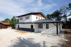 a white house with a black roof at Oreo - Destination Guyane in Saint-Laurent du Maroni +9 photos