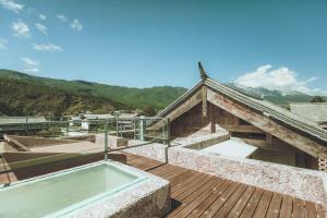 a house with a swimming pool on a wooden deck at tsingpu retreat in Baisha