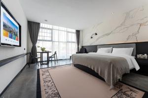 広州市にあるMankalun Hotelのベッドと薄型テレビがあるホテルの部屋 +70枚の写真