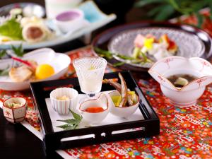 a tray of food on a table with dishes of food at Kanko Hotel Tamaru in Nara