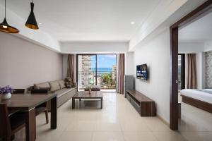 a living room with a couch and a table at Sanya Xintai Seaview Hotel in Oujiayuan