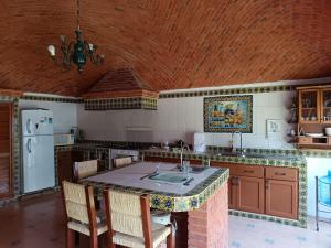 a kitchen with a kitchen island with a counter top at Villa Colibri in Tequisquiapan