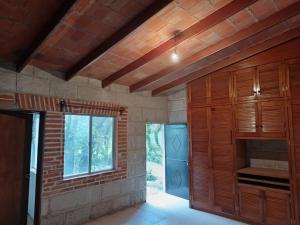 a kitchen with wooden cabinets and a window at Villa Colibri in Tequisquiapan +14 photos