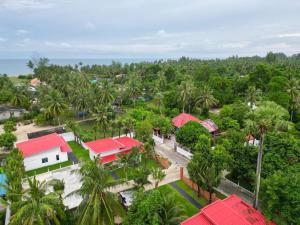 an aerial view of a village with palm trees at VS Resortวีเอส รีสอร์ท ท่าศาลา in Ban Thang Khun