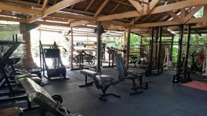 a gym with a lot of exercise equipment in it at Ilakai Hostel in General Luna