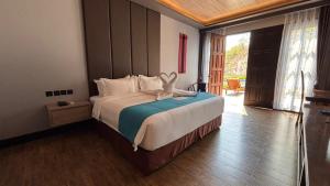 a bedroom with a bed with a stuffed animal on it at JL World Hotel Dili in Dili +72 photos