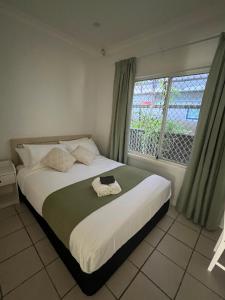 a bedroom with a large bed with a window at Double room with shared bathoom in Auburn