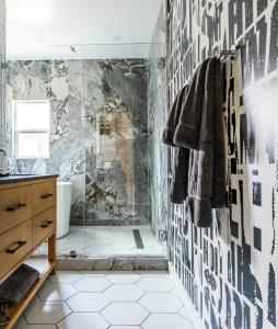 a bathroom with a shower with black and white tiles at Simple La Jolla Epic bungalow #1 in San Diego +8 photos