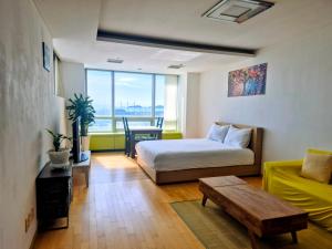 a room with a bed and a couch and a table at Cozy - Experience Home like Comfort Studio in Incheon