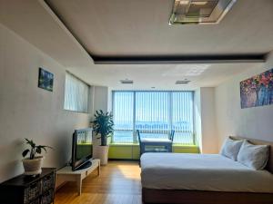 a bedroom with a bed and a television in it at Cozy - Experience Home like Comfort Studio in Incheon
