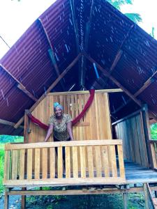 a woman is sitting in a wooden play structure at Posada Brisas del Cachcal in Panguí