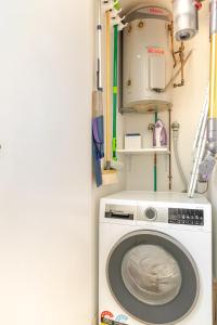 a laundry room with a washing machine at Stylish and perfectly located Bondi Beach hideaway in Sydney