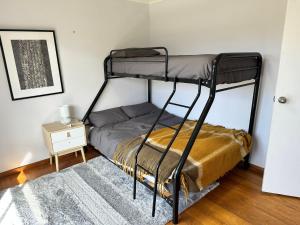 a bedroom with a bunk bed and a night stand at Saturn Sands - 30 Saturn Parade in Venus Bay