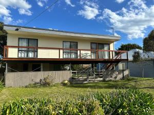 a house with a large deck on top of it at Saturn Sands - 30 Saturn Parade in Venus Bay