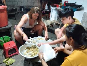 a group of people preparing food in a kitchen at ZOZO Sapa Homestay & Trekking in Sa Pa