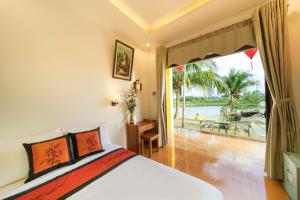 a bedroom with a bed and a large window at Lakeview Villa Homestay in Hoi An +43 photos