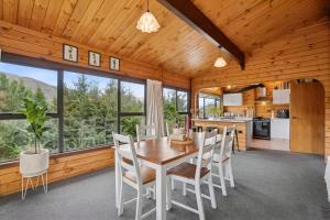 a kitchen and dining room with a table and chairs at Family-Friendly Chalet Mountain Views in Frankton Wharf
