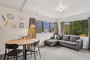a living room with a couch and a table at Family-Friendly Chalet Mountain Views in Frankton Wharf