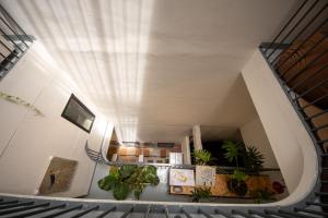 a spiral staircase with potted plants in a building at The Brownstone Hostel & Space in Ipoh