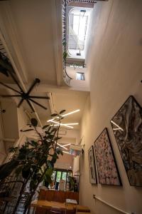 a room with a table and a ceiling with a window at The Brownstone Hostel & Space in Ipoh