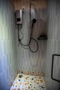 a shower in a tiled bathroom with a tile floor at The Brownstone Hostel & Space in Ipoh +66 photos