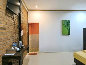 a living room with a brick wall at Wanajaya Homestay 