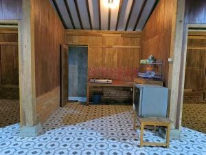 an empty room with a tv sitting on a chair at Wanajaya Homestay by ABM in Terong