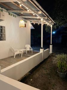 a patio with two chairs and a bench under a pergola at El Cortijo 