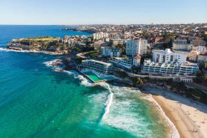 an aerial view of a beach with buildings and the ocean at Stylish and perfectly located Bondi Beach hideaway in Sydney