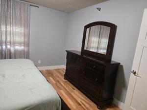 a bedroom with a dresser with a mirror on it at Eden Prairie Home in Eden Prairie