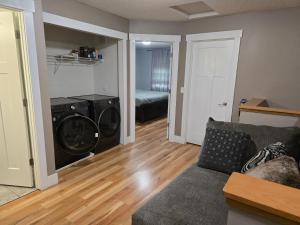 a living room with a washing machine and a couch at Eden Prairie Home in Eden Prairie