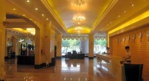 a lobby with a person standing at a counter at Fujian Galaxy Garden Hotel in Fuzhou