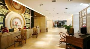 a lobby of a building with people sitting in chairs at Longda Ruiji Business Hotel Harbin in Harbin