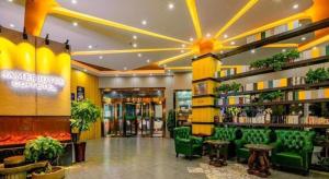 a lobby of a store with green chairs and books at James Joyce Coffetel Xi'an Laochenggen Hongmiaopo Metro Station in Xi'an
