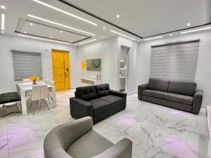 a living room with two couches and a table at FYV Beach Villas in San Juan