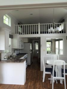 a kitchen with a table and a dining room at Circle M Camping Resort Loft Park Model 23 in Wabank