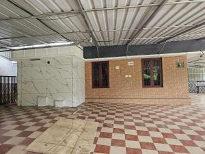 an empty room with a checkered floor in a building at Hamai nisha villa in Ambalavayal