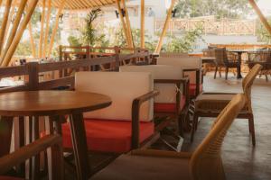 a row of tables and chairs in a restaurant at Statler Private Beach Villa Mandalika in Kuta Lombok