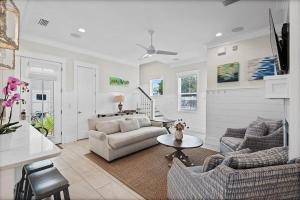 a living room with a couch and a table at Mermaid Cove in Inlet Beach