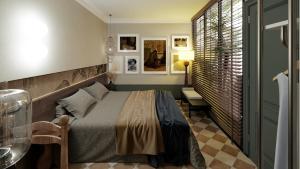 a bedroom with a bed and a table and a window at A Stay In Bàu Vá in Hue