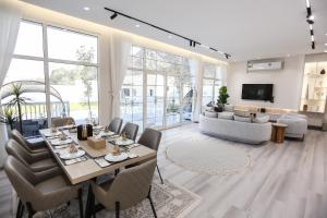a living room with a table and chairs and a couch at paradise resort and spa in Hatta