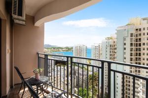 a balcony with a table and a view of the ocean at Sanya Xintai Seaview Hotel in Oujiayuan