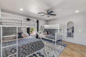 a bedroom with two bunk beds and a ceiling fan at The Golden Hour Getaway Pool Lake Views Games in Abbeyville